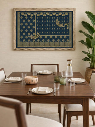 Framed Midnight Crest navy and gold wall art in a weathered wood frame above a walnut dining table set with plates and glassware