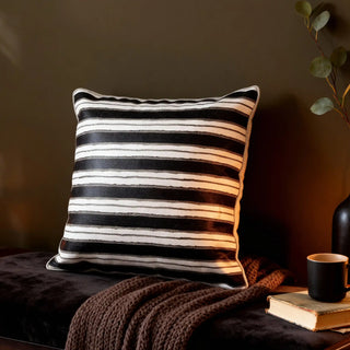 Midnight Linea cushion cover styled in a moody, modern setting with dark walls.