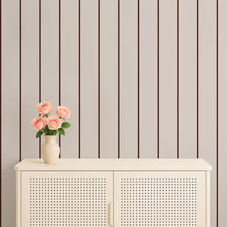 Minimal beige & brown striped wallpaper styled behind a cream console with pink roses in a vase, creating a calm and sophisticated atmosphere.