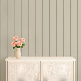 Gray and beige striped wallpaper behind a cream console with a vase of pink roses, adding understated charm to the room.