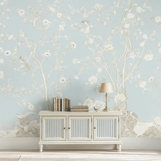 A wall view of the Mint Blossom Vintage Chinoiserie Wallpaper in light blue, showing its continuous floral and botanical design.