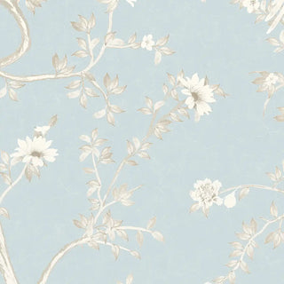 A close-up highlighting the intricate hand-painted style blossoms and branches in cream tones on the blue background.