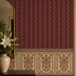 The Miras maroon stripe and damask paneling wallpaper styled elegantly above a dark wood sideboard next to a gold-framed arch mirror.