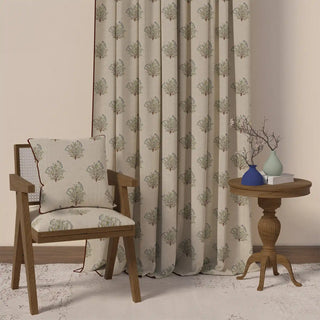 The Mithoo Pipin curtain styled in a room with a chair and table, demonstrating its peaceful and natural feel.