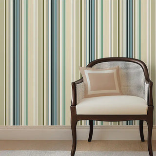 Modern Green & Teal Layered Stripe Wallpaper Roll behind a cushioned armchair with beige pillow, creating a stylish and inviting corner space.