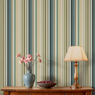 Living room styled with Modern Green & Teal Layered Stripe Wallpaper Roll, paired with a wooden console, ceramic vase with pink flowers, and warm lamp.