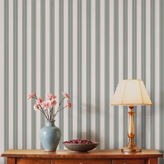 Modern Grey & Beige Wide Stripe Wallpaper Roll displayed in a living room with a wooden console table, ceramic vase with flowers, and warm ambient lighting for a cozy setting.