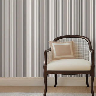 Modern Grey Layered Stripe Wallpaper Roll styled with an accent chair and cushion, creating a sophisticated modern corner setting.