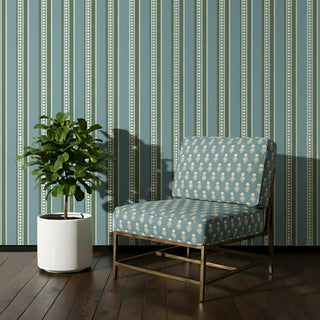 Accent chair upholstered in Mogra Upholstery Fabric featuring soft blue base with cream floral motifs, styled against a striped wall.