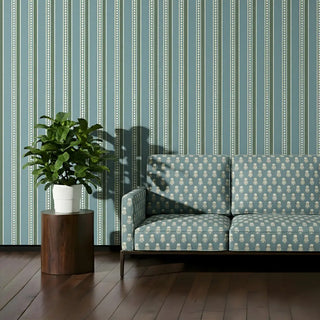 Sofa upholstered in Mogra Upholstery Fabric with floral designs, placed in a modern living space with wooden flooring and indoor plant.