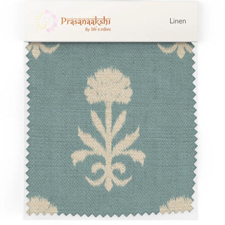 Fabric swatch of Mogra Upholstery Fabric showing bold mogra flower motif in cream on a textured blue background.