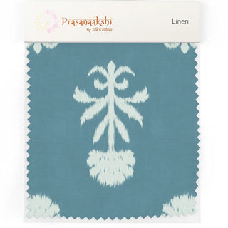 Close-up linen swatch of the Mogra upholstery fabric in teal blue, showing the ivory ikat floral motif with its feathered edges.