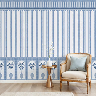 Monsoon Arches Wallpaper: View of the vertical striped wallpaper and decorative border behind a chair.