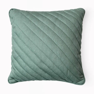 Full studio shot of the Moss Drift Cushion showing the diagonal quilted pattern.