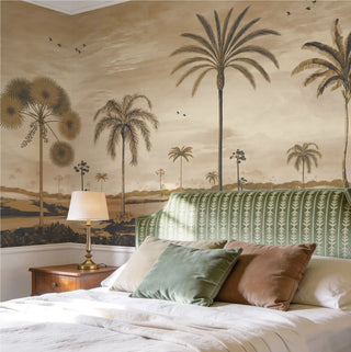 A luxury bedroom featuring the Mosslight Morning vintage sepia mural behind a bed with a green striped headboard and velvet cushions.