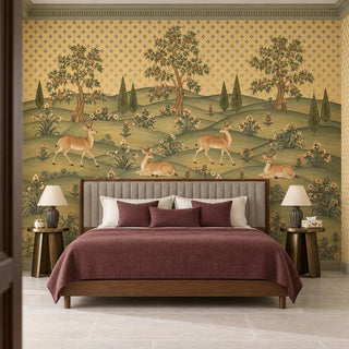 The Mriga Vatika wallpaper mural behind an upholstered bed with a plum throw and brass side tables, deer resting among the hills view-bedroom