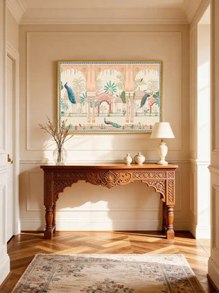 Mughal Garden wall art with peacock and architectural motifs styled in a sunlit foyer above a long, ornate wooden console table.