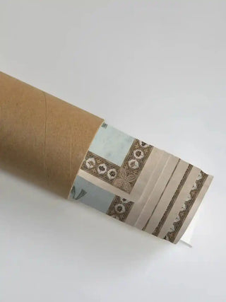 Musical Evening wall art print in meadow green rolled in a kraft shipping tube, showing the pale floral and gold border detail.