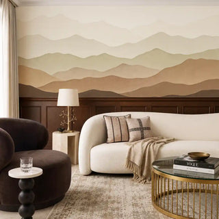 The Muted Horizon sienna sage wallpaper mural installed on a feature wall in a living room with a cream boucle sofa and dark wood panelling view-livingroom