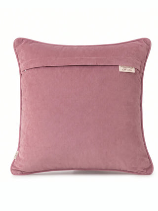 The reverse of the Naqkashi cushion cover in plain pink with an overlap closure, mauve piping and a woven brand label.