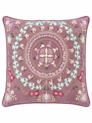 The Naqkashi embroidered cushion cover showing a mauve ground with a floral roundel, an aqua scrolling leaf wreath and red blooms at the base.