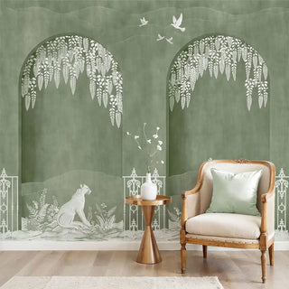 A full-scale Neel Upvan sage green wall mural featuring a hand-sketched Indian landscape with deer, trees, and traditional arches.