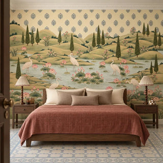 The Neer Kamal wallpaper mural behind a wooden bed with a terracotta throw and pleated bedside lamps, cranes wading among pink lotuses view-bedroom