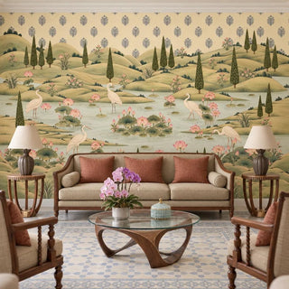 The Neer Kamal wallpaper mural with white cranes and a lotus pond behind a beige sofa with terracotta cushions and a glass coffee table view-livingroom
