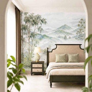 The Nilgiri luxury scenic mountain wallpaper mural installed behind a beige upholstered bed in a serene master bedroom layout.