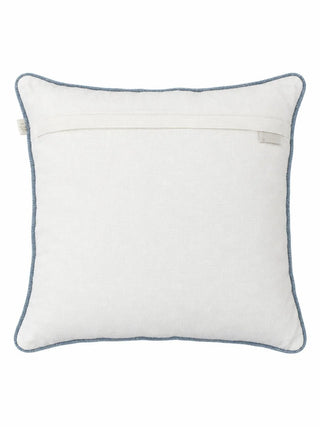 The reverse of the Noorani cushion cover in plain ivory with an overlap closure and blue piping around the edge
