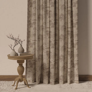 The Nritya Fringes curtain, showcasing its serene, tone-on-tone pattern of trees and animals on a light beige fabric with a matching fringe.