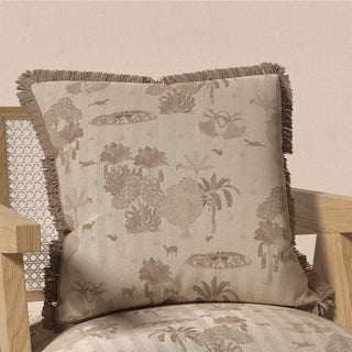 The Nritya Fringes cushion cover resting on a light-colored wooden chair, demonstrating its elegant and calming presence in a home setting.