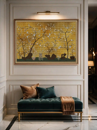 A detailed macro close-up of the The framed Oriental Garden Chinoiserie wall art displayed above a teal velvet bench in a panelled entryway, lit by a wall-mounted picture light.