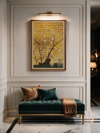 The framed vertical Oriental Garden Chinoiserie wall art displayed above a teal velvet bench in a panelled entryway, lit by a wall-mounted picture light.
