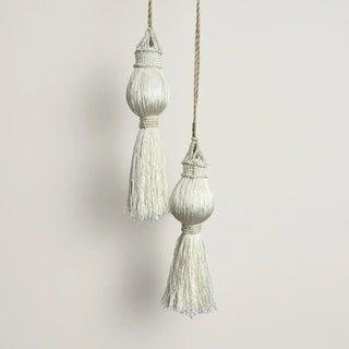 Close-up shot of the Moonlit Holdback hanging, highlighting the intricate beadwork and the shape of the large ivory tassel head.