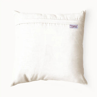 The back view of the Padma Leela ivory silk cushion showing the secure hidden flap closure and brand label.