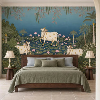 Padma Sarovar wallpaper behind a dark wood bed with a sage-green linen throw, flanked by round wooden bedside tables and cream lamps with ruffled shades.