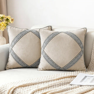 Two Diamond Weave Cushion Covers styled on a white sofa with a knitted throw.