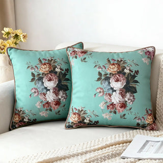 Two Flored Eden Bouquet Cushion Covers styled on a white sofa with a knitted throw.