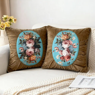 Two Florid Verona Bloom Cushions styled on a white sofa with a knitted throw.
