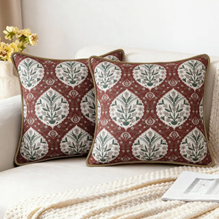 Two Gulmohar Sultan Garden Cushions styled on a white sofa with a creamy throw.