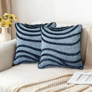Two Indigo Wave Cushions styled on a white sofa in a bright living room.