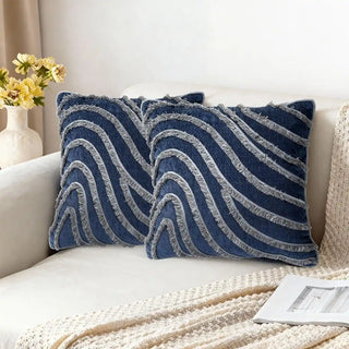 Two Regal Wave Cushions styled on a white sofa with a knitted throw.