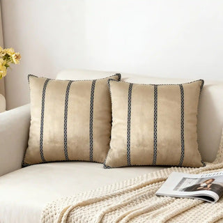 Two Riviera Band Cushion Covers styled on a white sofa with a knitted throw.
