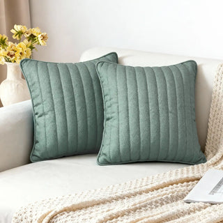 Two Sea Mist Cushions styled on a white sofa in a bright living room.