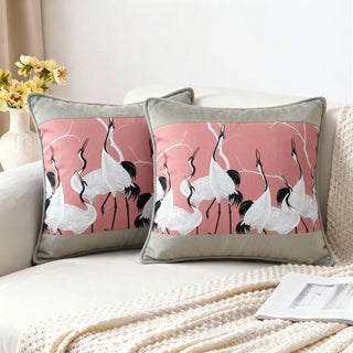 Two Sedge Poised Cranes Cushions styled on a white sofa with a knitted throw.