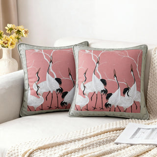 Two Sedge Serene Cranes Cushions styled on a white sofa with a knitted throw.