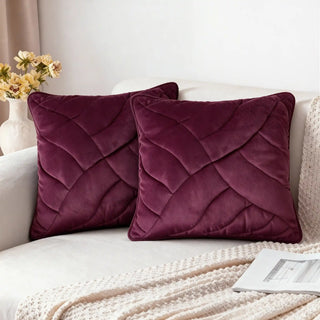 Two Velvet Dune Cushions styled on a white sofa in a bright setting.