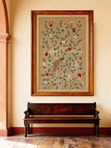 The Pakhi peacock art print styled inside a traditional stone archway above a woven cane bench.