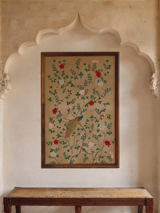 Large Pakhi wall art print in a dark frame styled on a neutral wall above a classic wooden entryway bench.